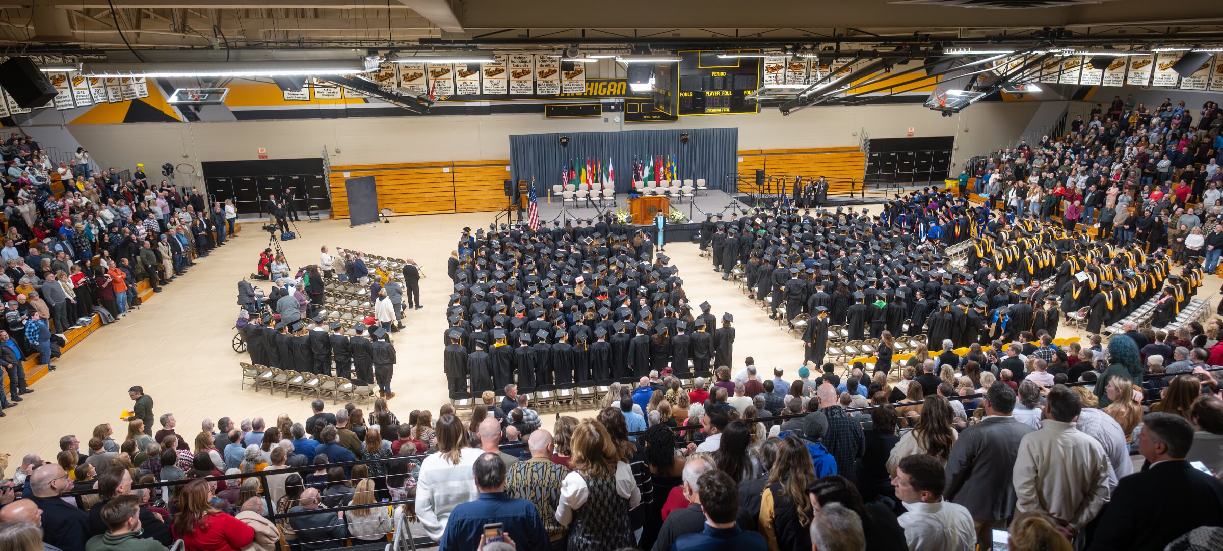 Audience of onlookers at Midyear Commencement in the Wood Gym at the SDC.