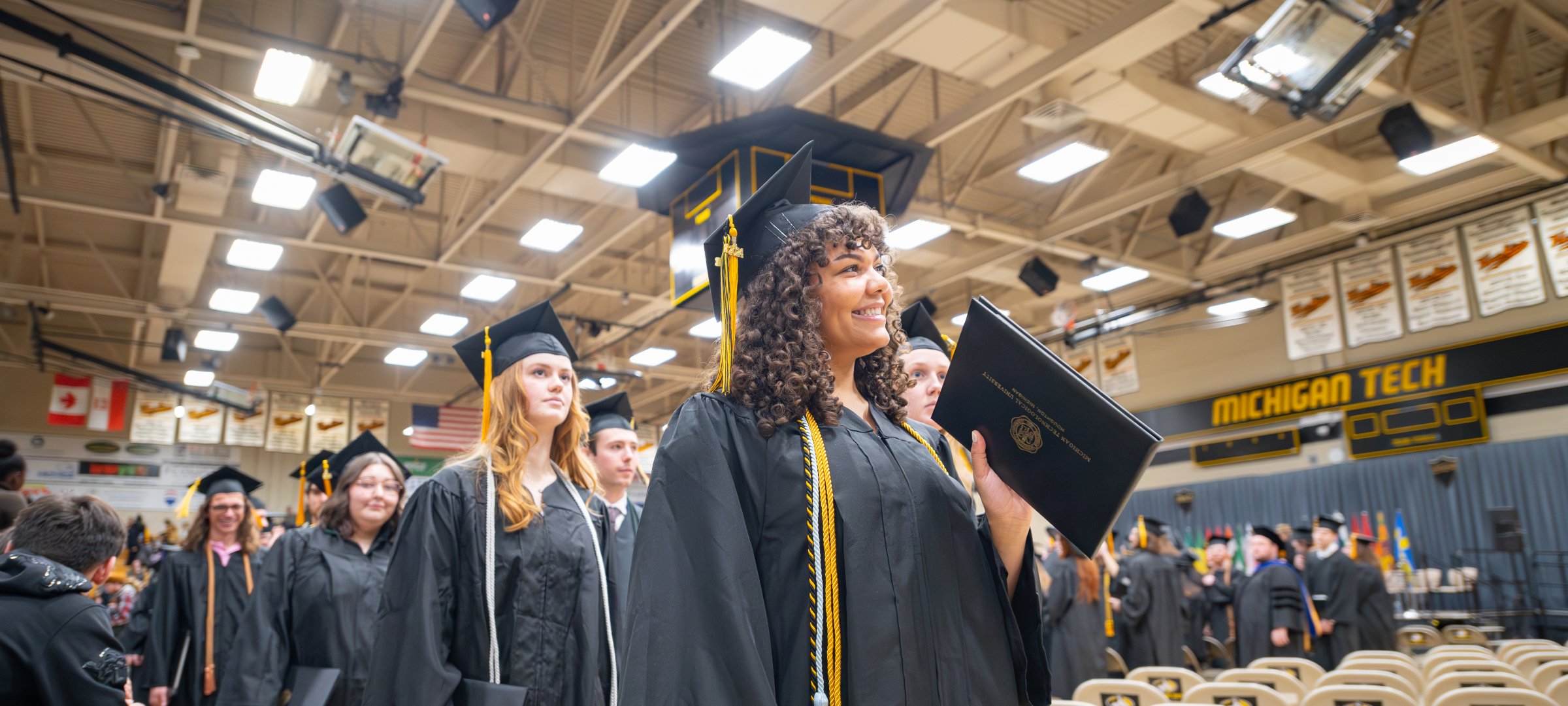 Midyear Commencement with student speaker at the podium