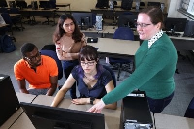 Left to right: MS in Data Science students Michael Ngala, Sneha Kaiki, and Charlotte Hildebrandt, and Laura Brown