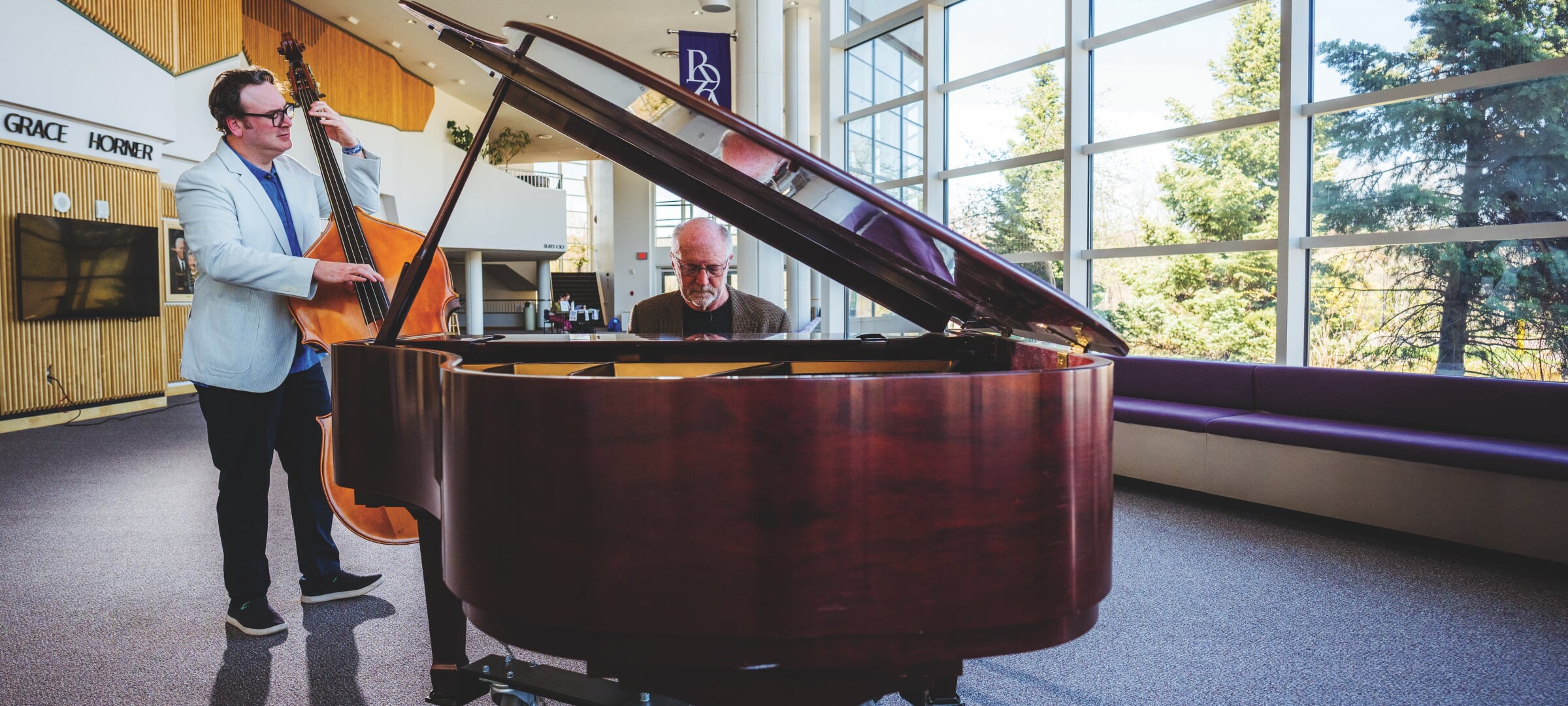 Dan Fuhrmann playing the piano while Tim Havens plays bass next to him.