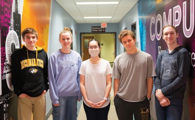 Five members of the Copper Country Coders standing in a hallway.