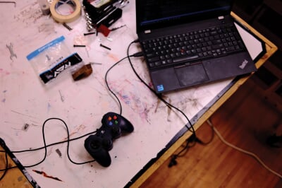 Remote control hooked up to a laptop.