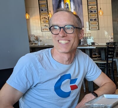 Scott Diehl sitting at a table and smiling.