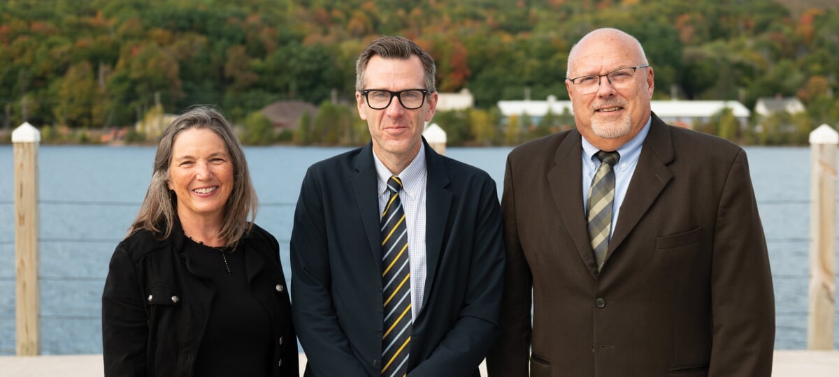 Dianne Marsh, Dennis Livesay, and Mark Gauthier standing in front of the Keweenaw Waterway.