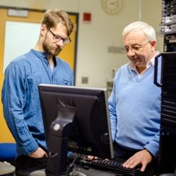 Soner Onder and Student Standing at Computers