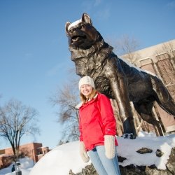 Female student by Huskly statue