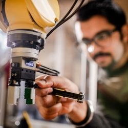 Male with wrench and robot