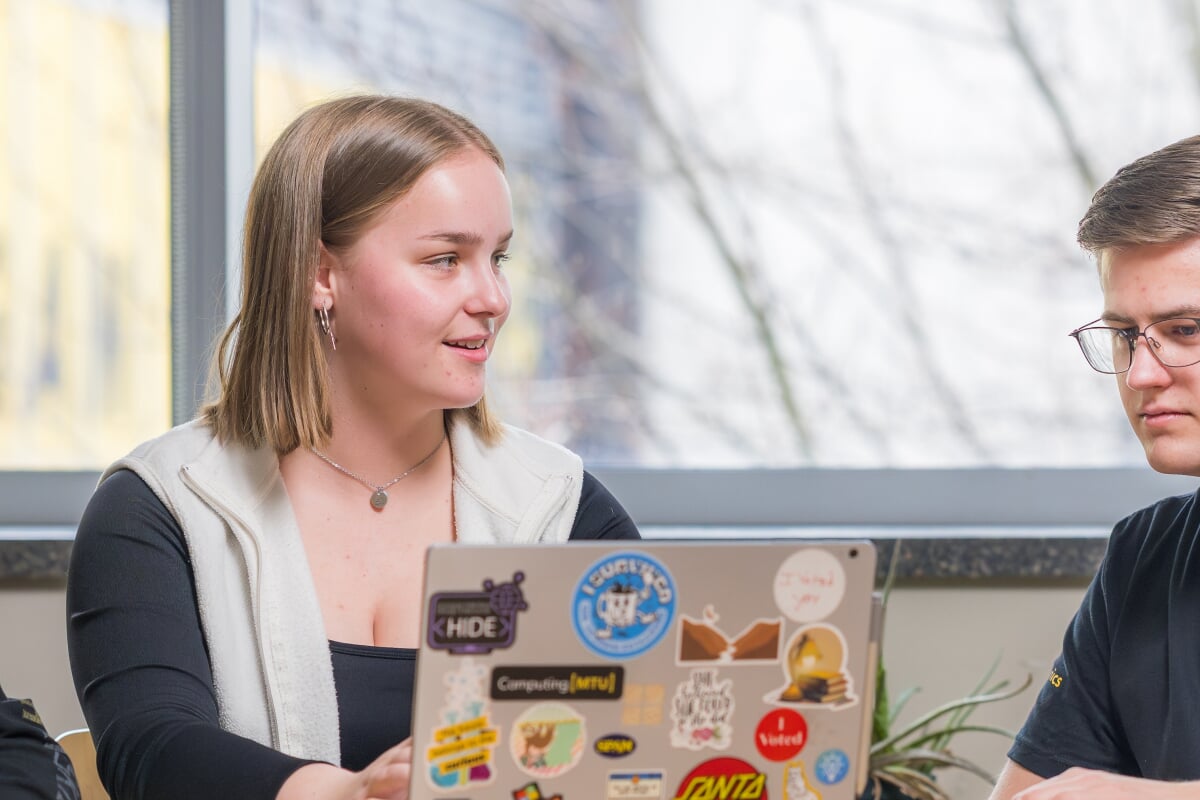 A college of computing student at Michigan Tech with her laptop
