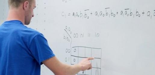 Student working a problem on a dry erase board.