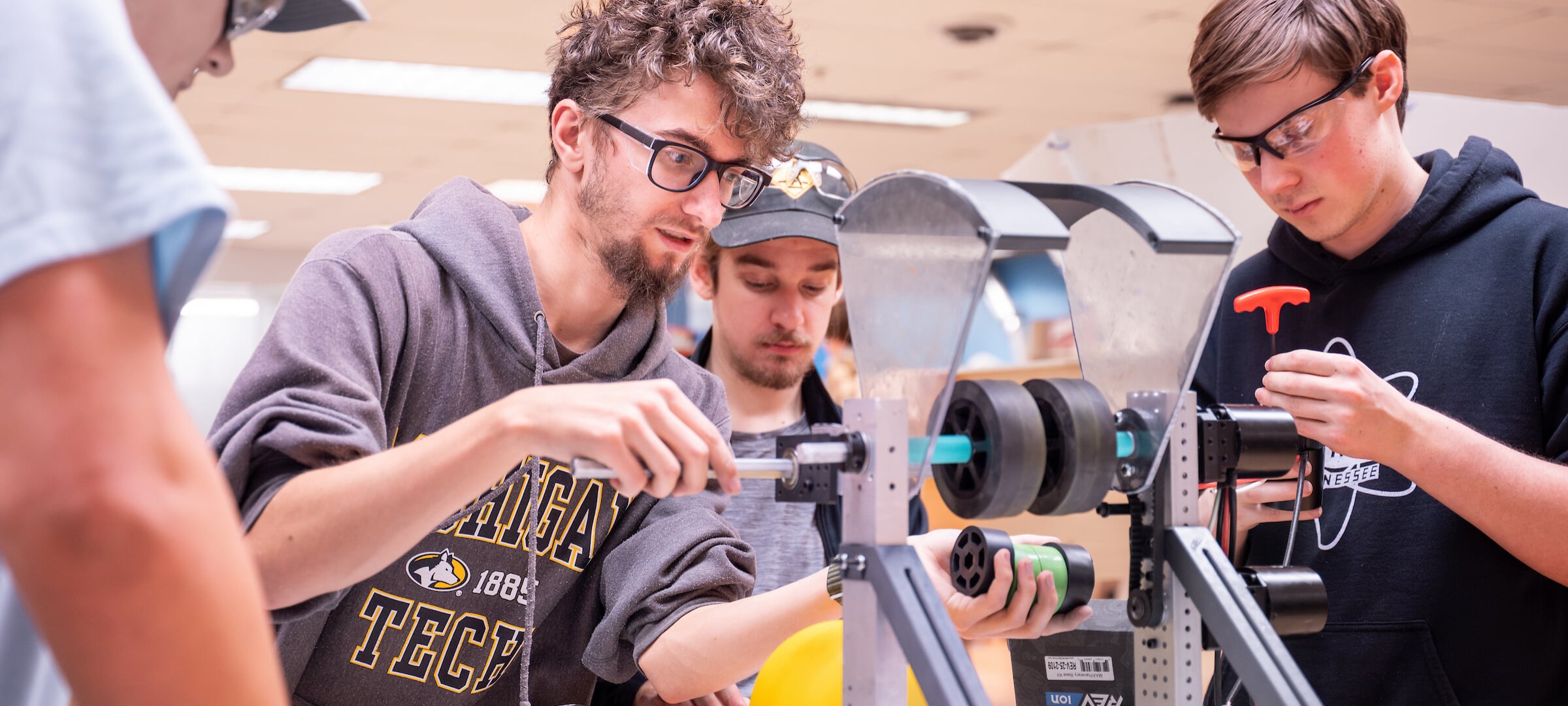 Undergraduate students building a robot.