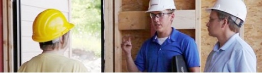 Workers in hardhats inside a building under construction