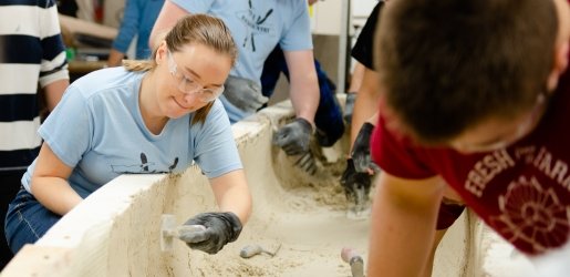 Students working on a concrete canoe 