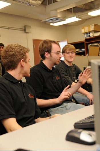 Computer Science enterprise students collaborating on a project in a lab.