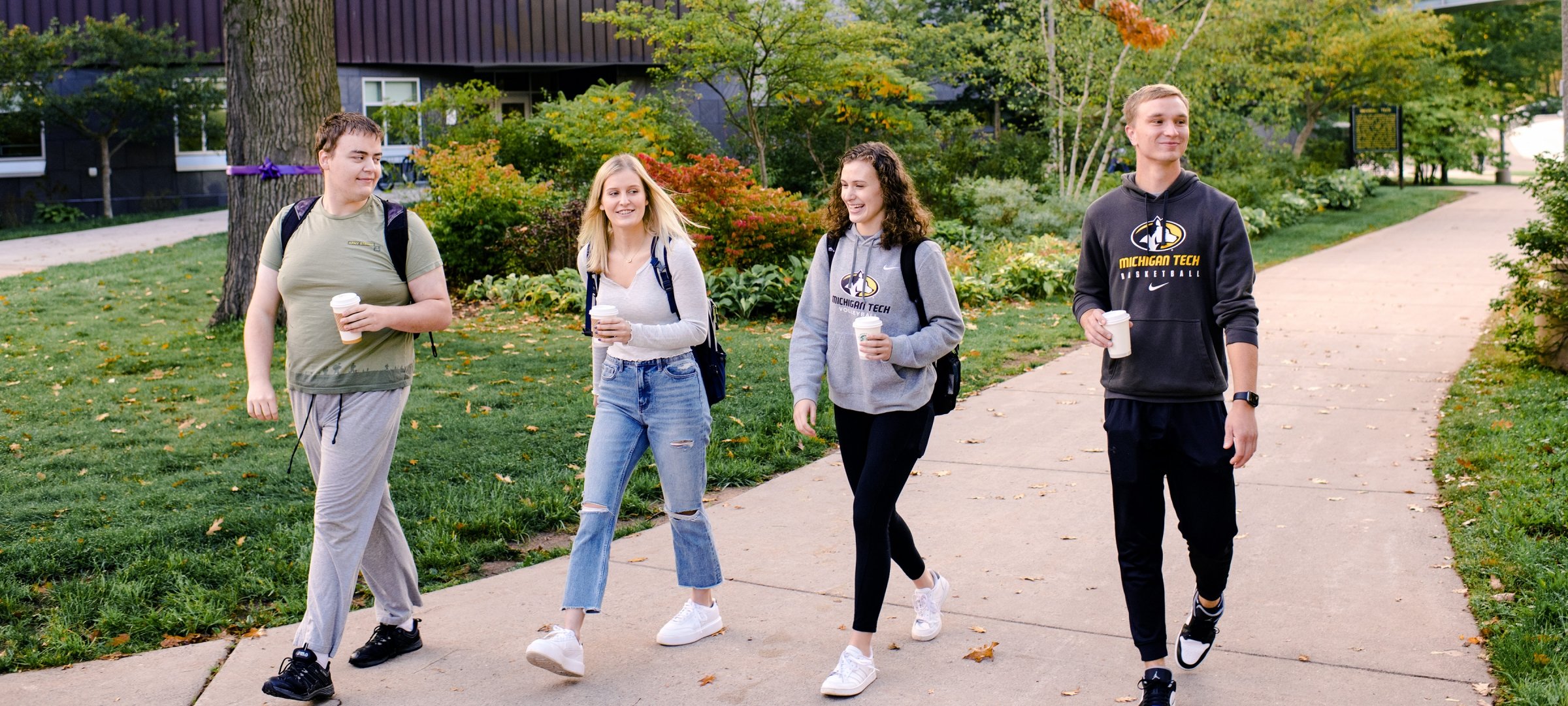 Michigan Tech students walking by Rekhi Hall in fall