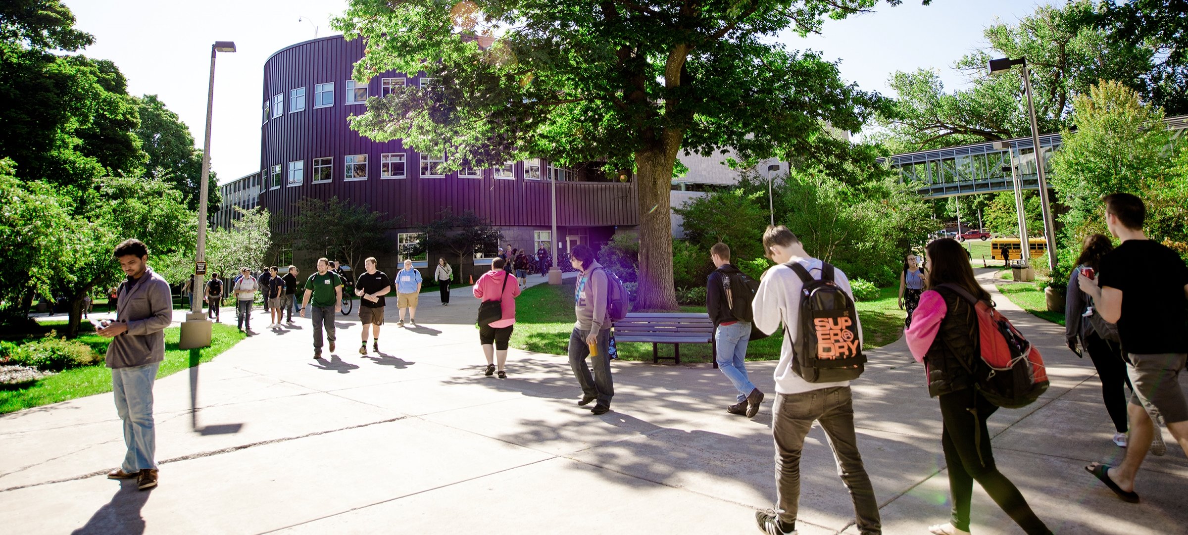 Michigan Tech students walk by Rekhi Hall in the summer