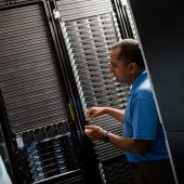 Researcher standing and explaining in server room