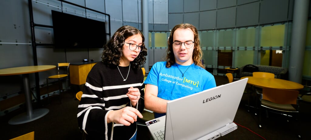 Michigan Tech data science students work in the round lounge of Rehki Hall on campus.