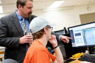 faculty member with student in computer lab