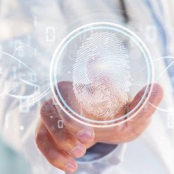 A hand reaches towards a holographic display shows a fingerprint scanner.