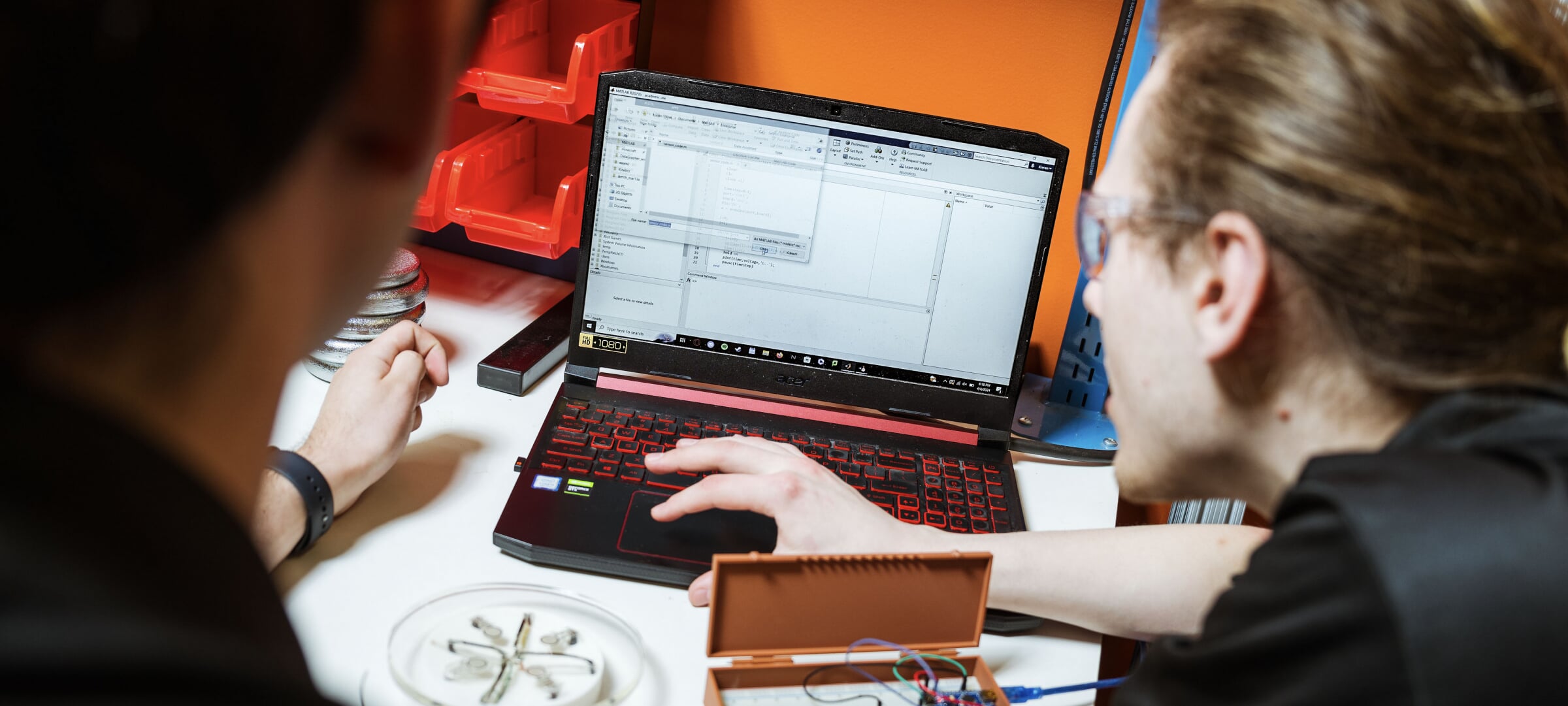 Students analyze test data on a laptop