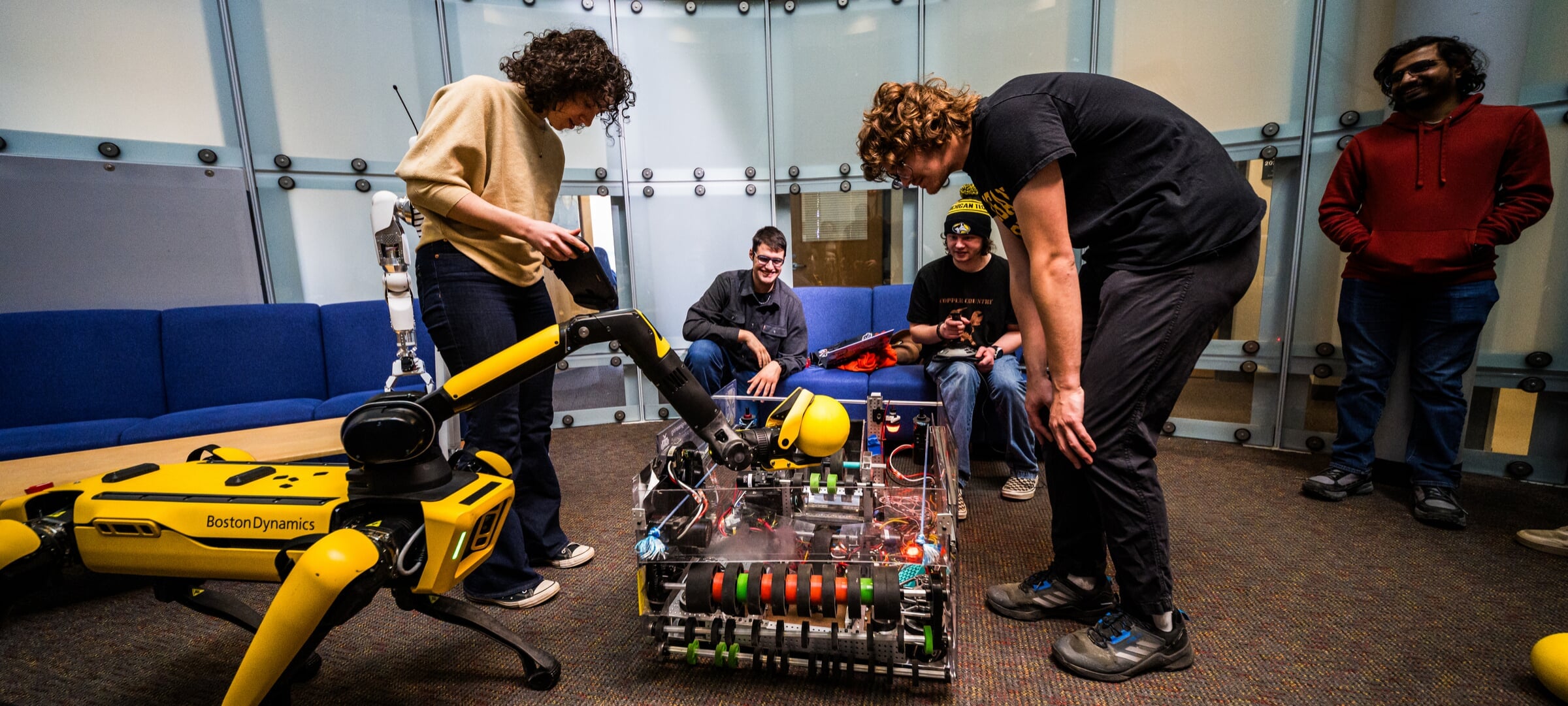 Balto the robotic dog may appear anywhere....It's friendly! Students playing fetch with Balto the Robot Dog.