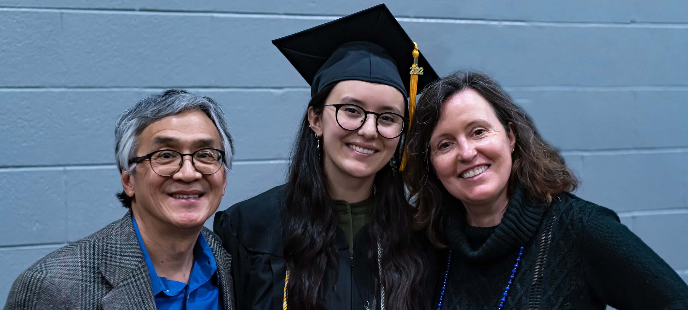Student with family at commencement.