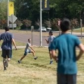 Student running others playing catch