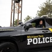 Officer inside Public Safety vehicle