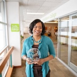 Dar Slade holding the 2019 Bayard Rustin Award