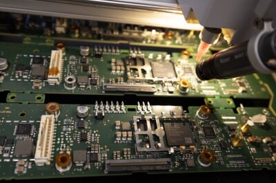 A circuit board being examined by a camera
