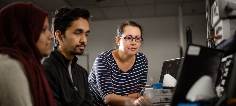 A professor showing her students electrical systems. 