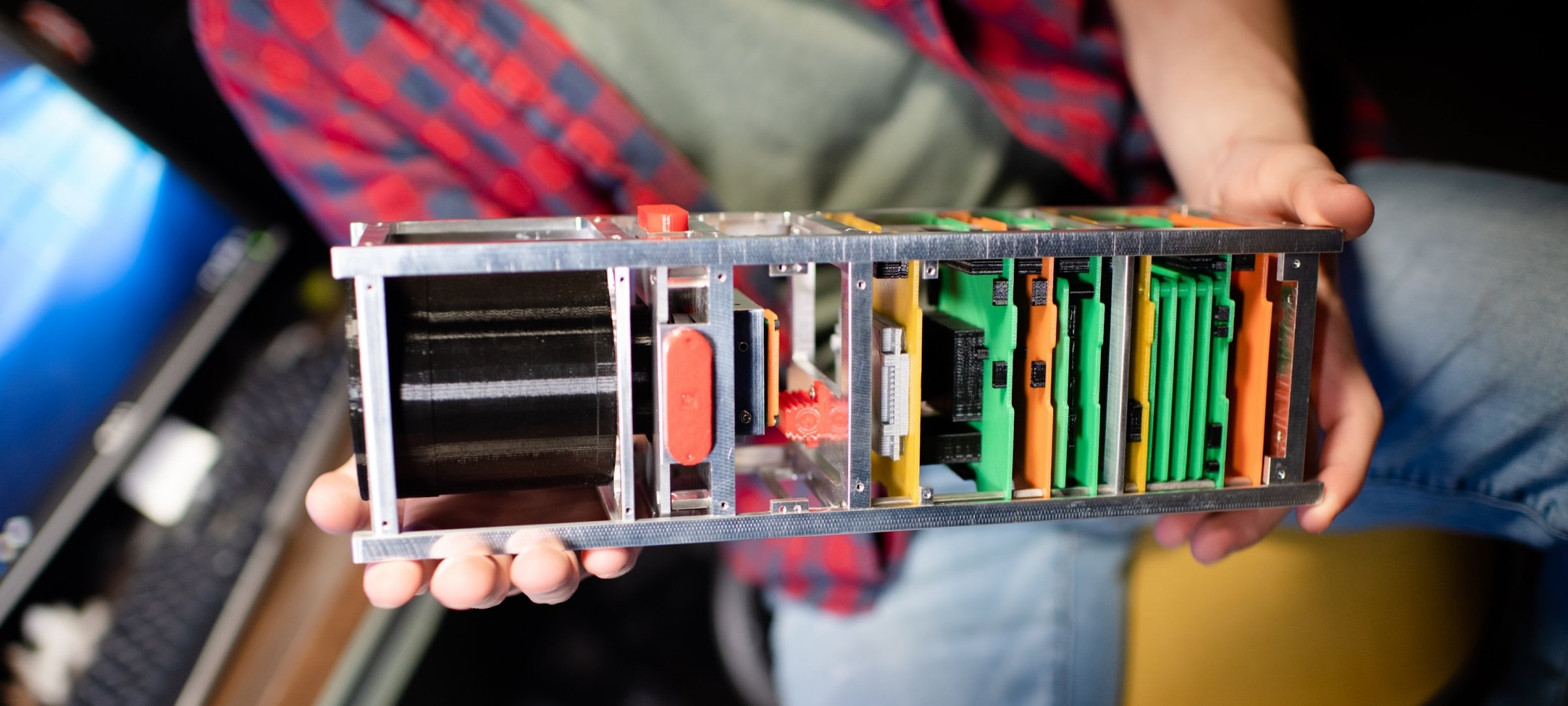 Student holding a satellite electrical device.