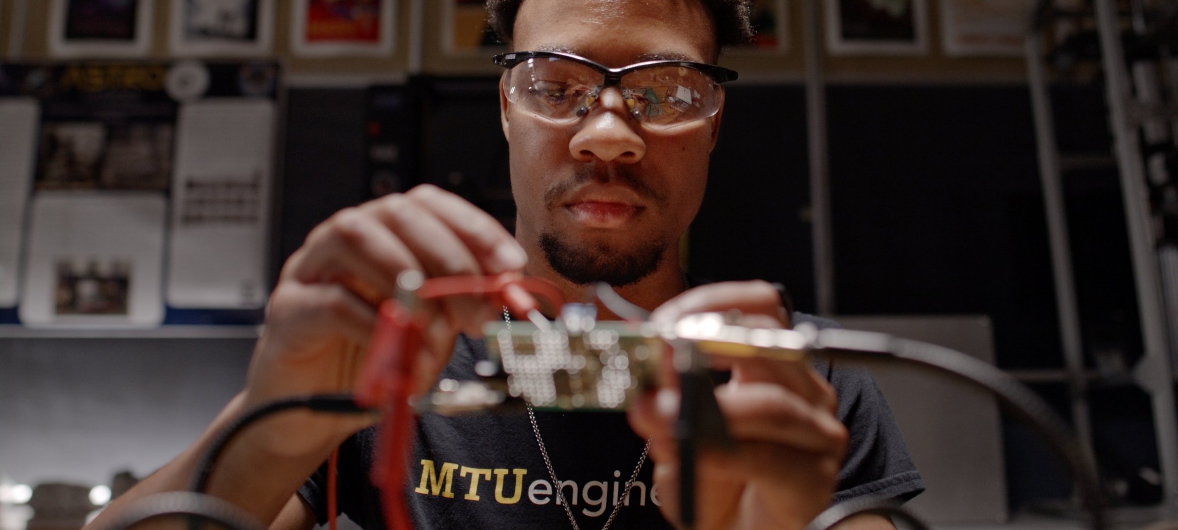 Student testing a circuit board.