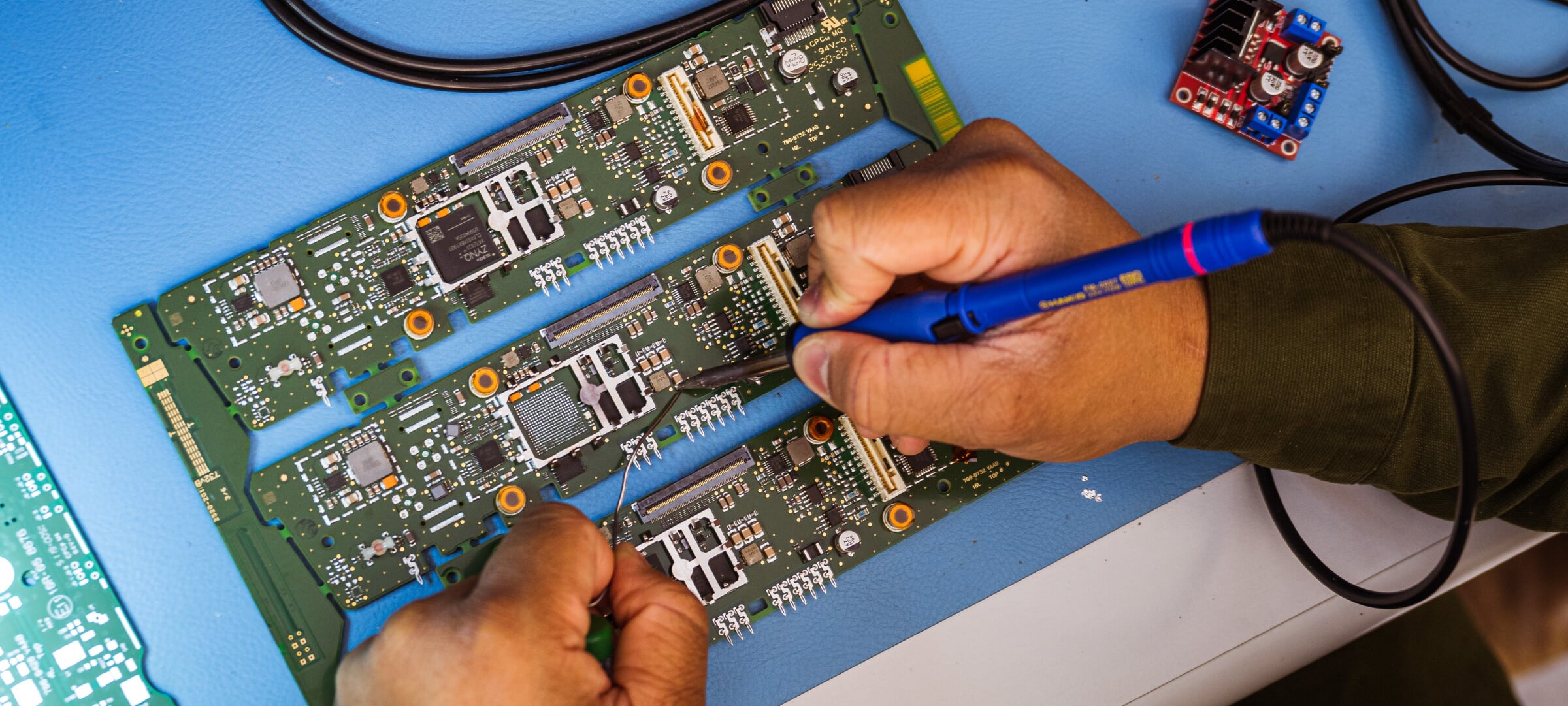Someone soldering a circuit board