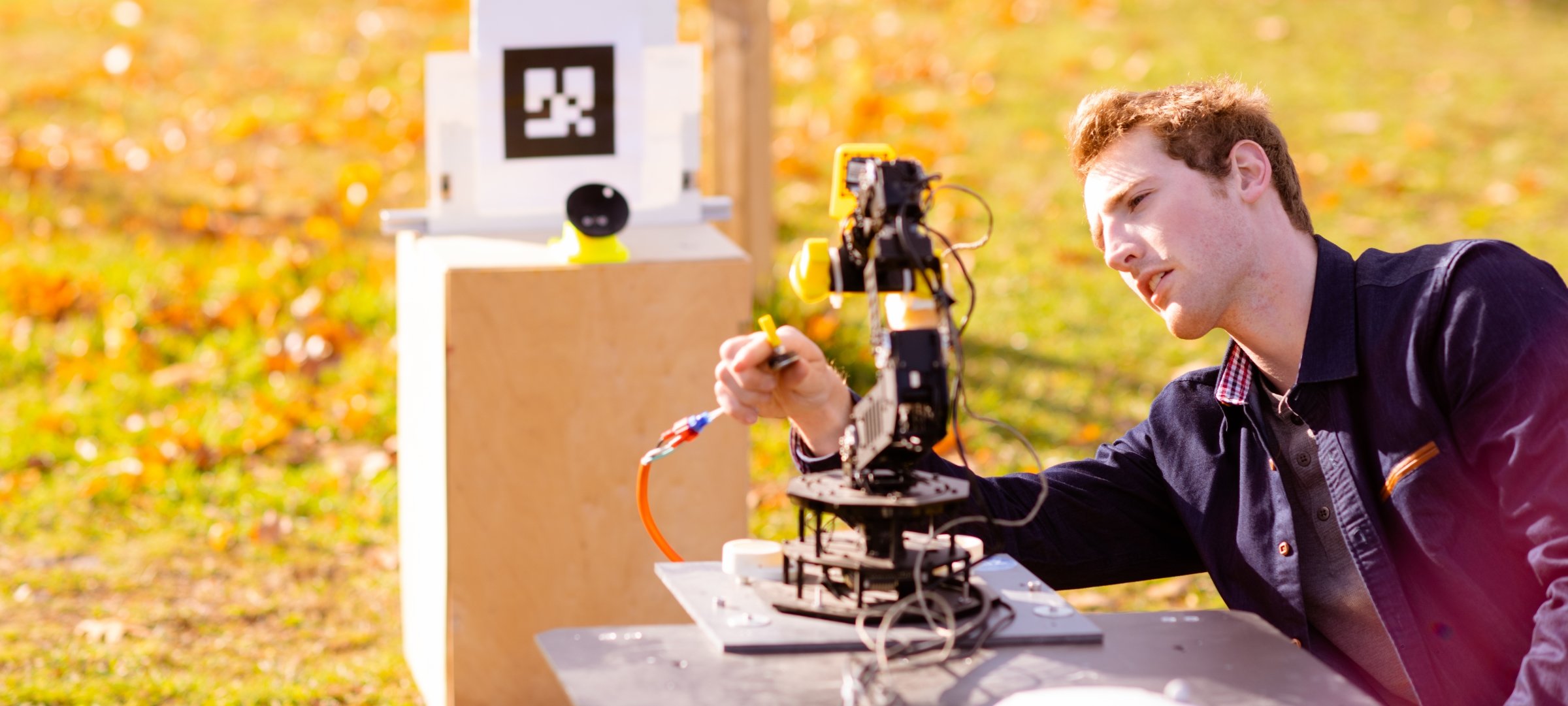 Student working on a robot in the field.