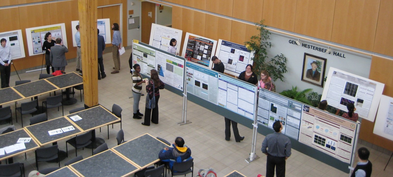Students and faculty at poster session in the Noblet building atrium.