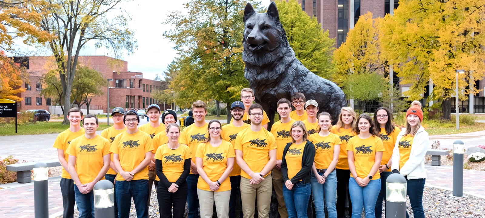 The LEAP group poses by the Husky statue on the campus of Michigan Tech.