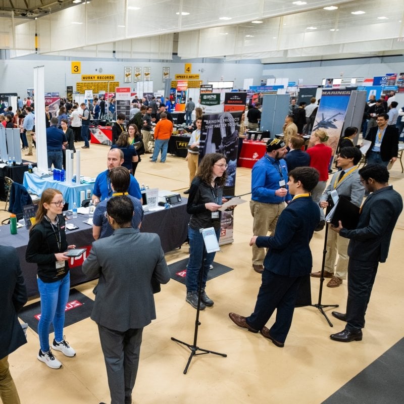 Large expo with booths, employers, and students.