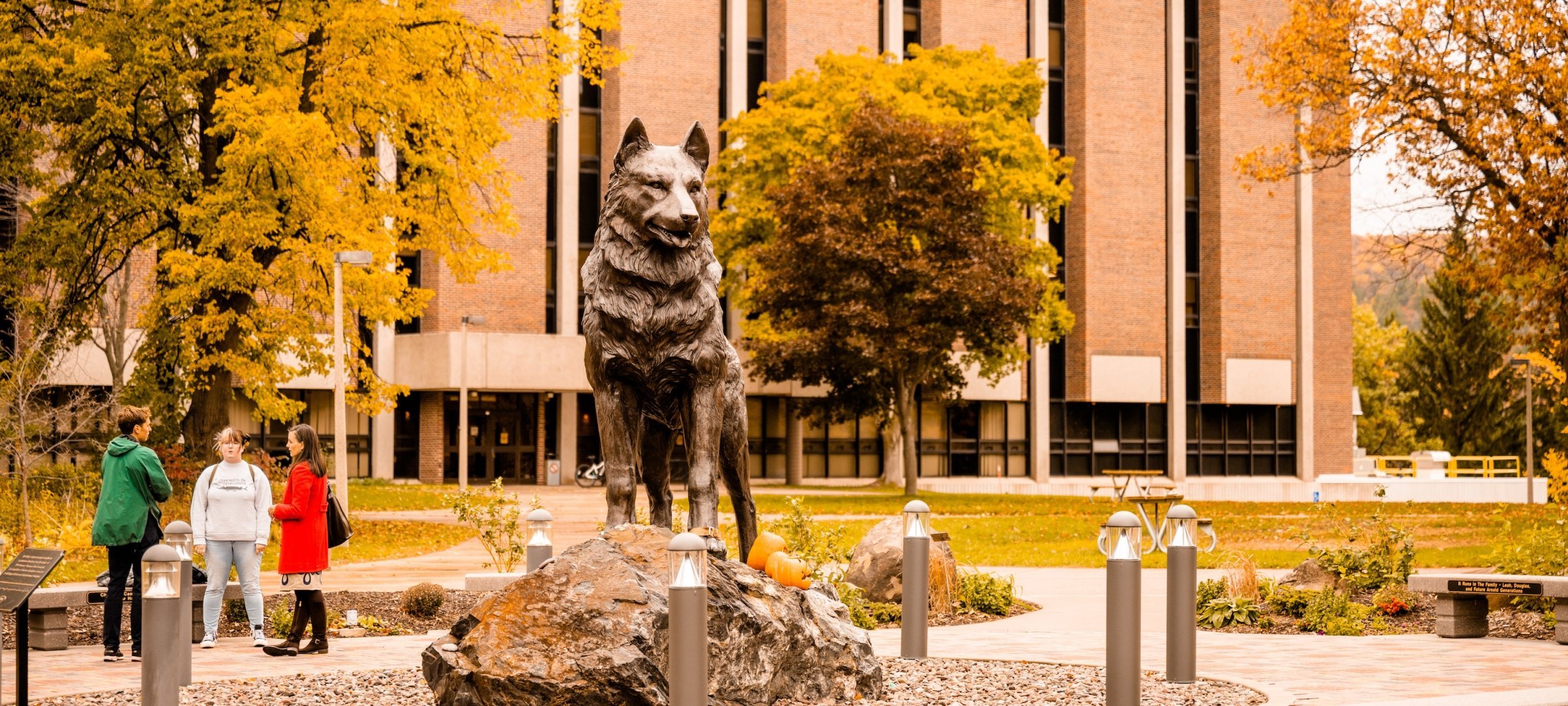 Students on campus near the Husky statue.