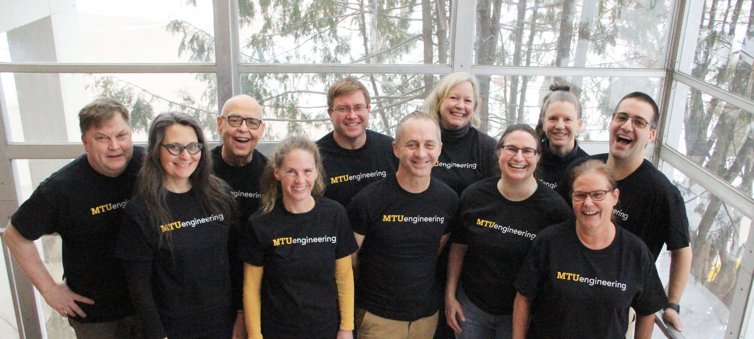Eleven faculty and staff pose with MTUengineering T-shirts.