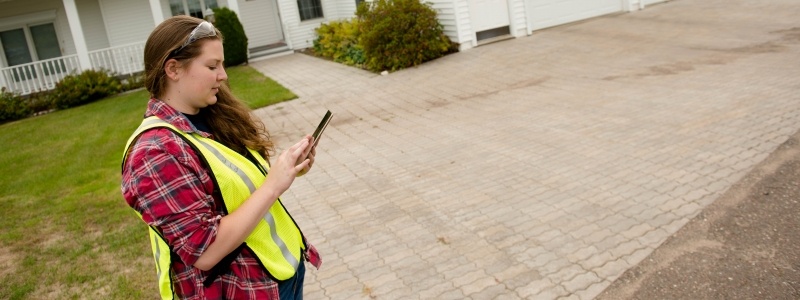 Safety worker checking information on a mobile device.