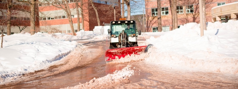 Snowplow clearing a sideway.