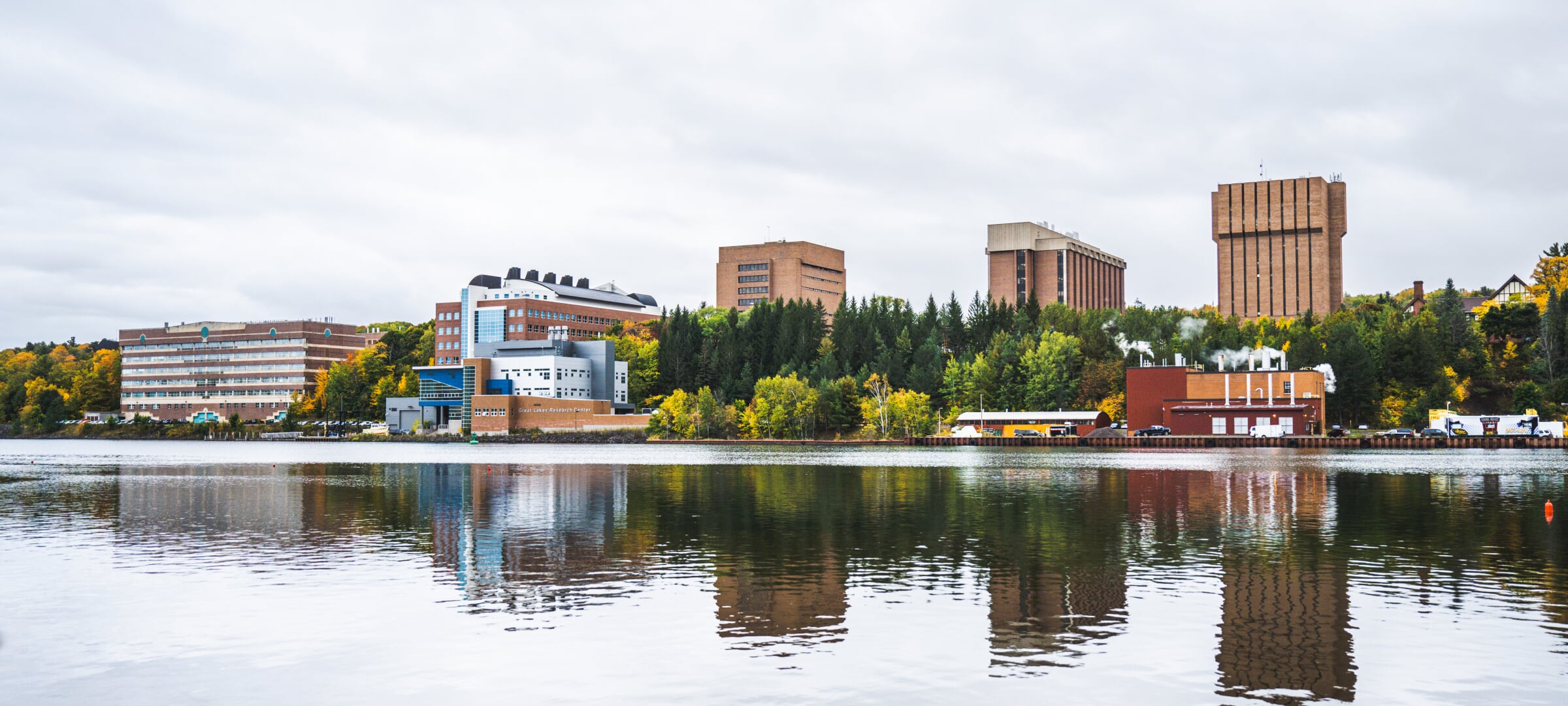 Michigan Tech campus in early autumn, featuring the Portage Canal.