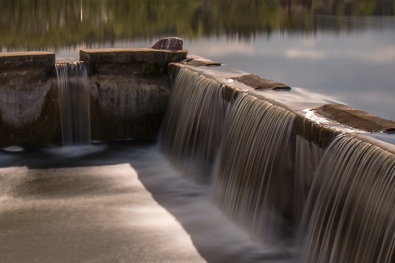 water flowing over dam