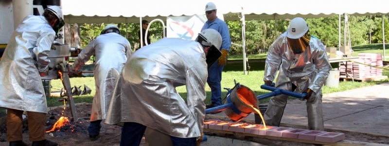 Materials engineers pouring liquid metal.