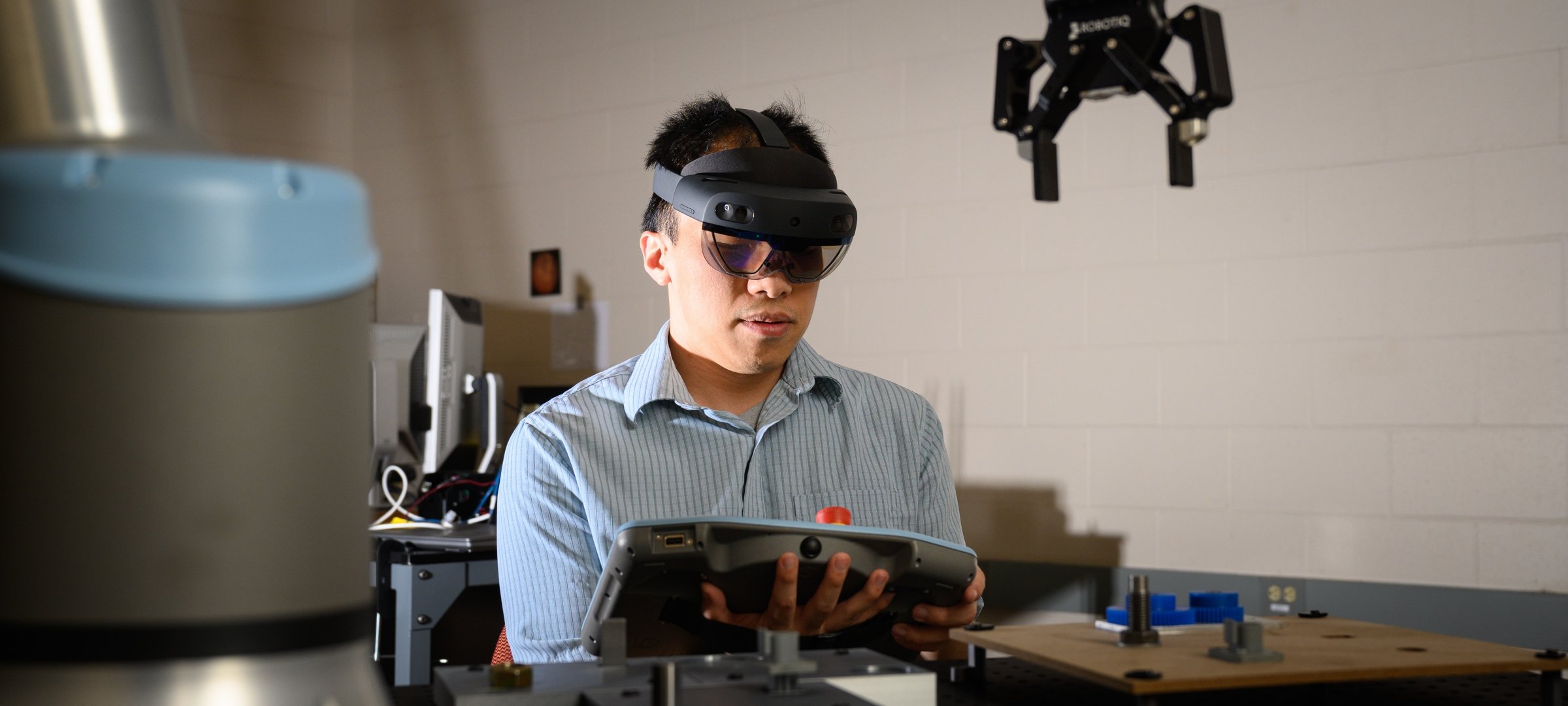 Advanced Manufacturing showing a researcher operating a controller.