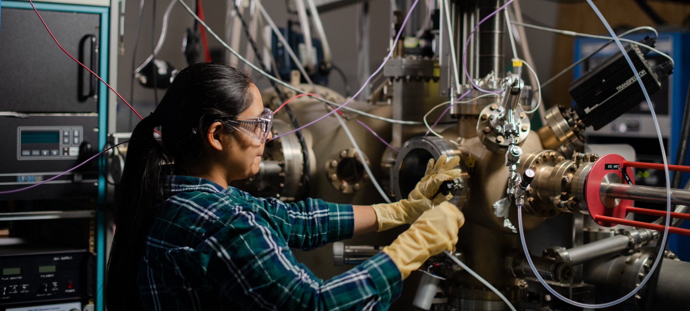 Researcher works on electronic equipment in the solar lab.