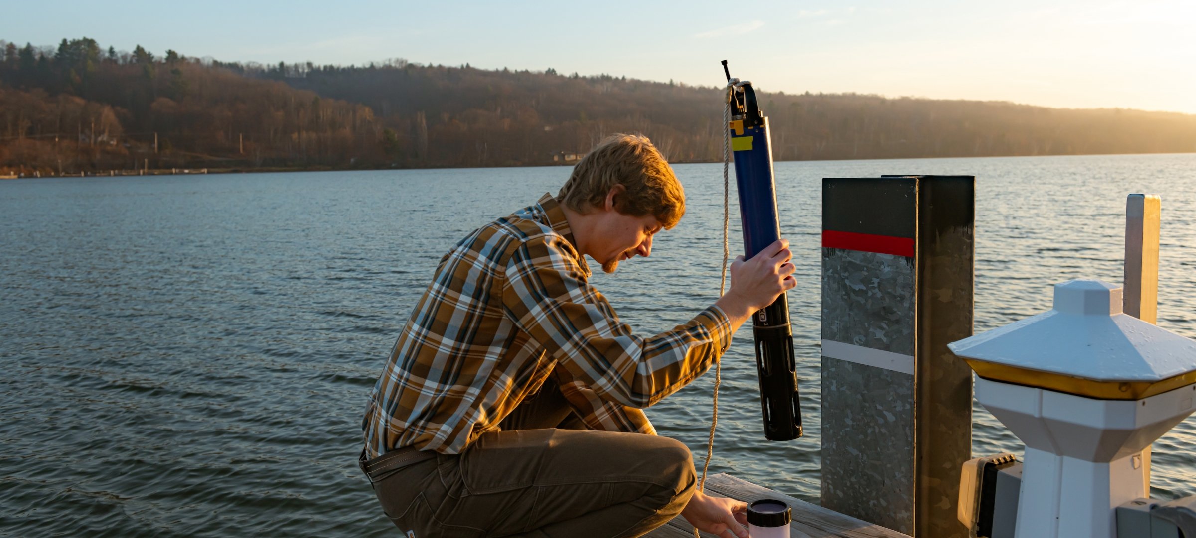 Researcher engaged in lake studies on the dock.