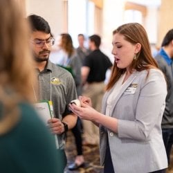 Two students discussing the design expo