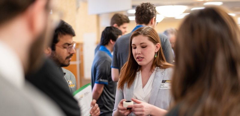 Steudents discussing their project during the in-person expo